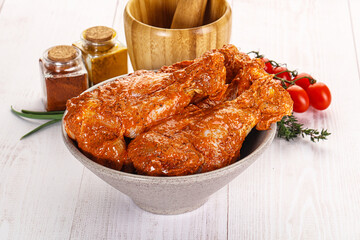 Raw turkey shoulder wing in Indian tandoori marinade