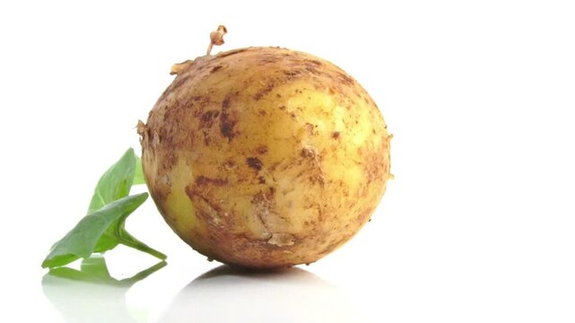 Whole Potato with basil leaves on white background isolated