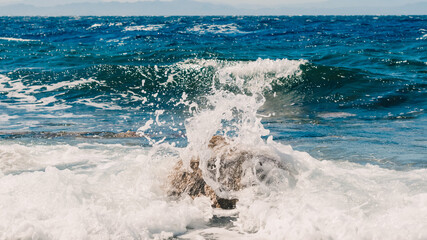 waves and splashes of sea surf and stones on the seashore in Egypt Dahab South Sinai