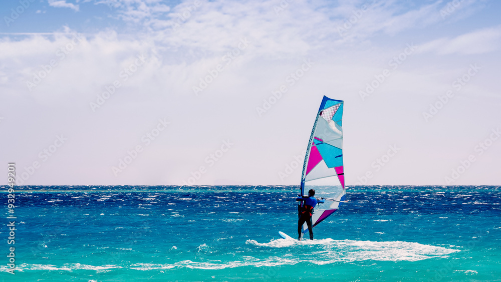 Poster surfer rides in the Red Sea in Egypt