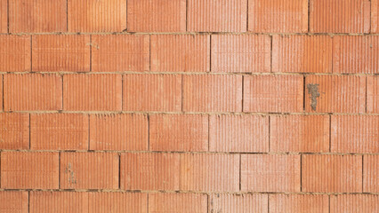 Texture of an orange-coloured brick wall