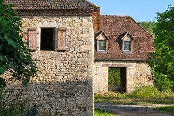 Empty natural stone farm house and barn in the last sunlight of the day in Cornac Lot Occitanie in Southern France