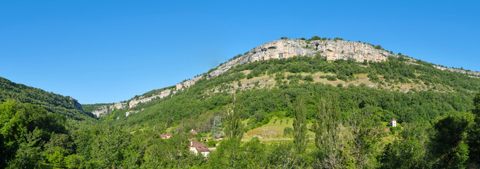 Panorama view of the mountains around Autoire Lot Occitanie in Southern France in summer. Just visible is the 13th century castle Chateau des Anglais also known as Château Fort La Roque d'Autoire