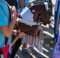 Fototapeta premium A horse's head on a hobby horsing stick in a child's hand