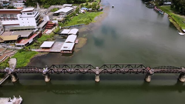 The Bridge River Kwai, Kanchanaburi, Thailand. The Death Railway, World War II, by the Japanese Army, which conscripted approximately 61,700 Allied prisoners of war. Opened 1943. Drone view. Video.