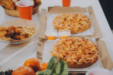 Group of young friends eating pizza.Home party.