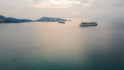 Aerial view, drone flying over Phuket city, Thailand. Drone over Patong Beach on Sunday in Phuket and tourists shopping at a street full of local merchants selling food, people resting by the sea.