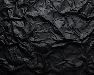 Crumpled black paper texture abstract background with copy space for text
