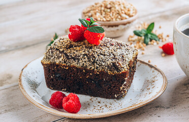 Delicious portion-sized brownie made from green buckwheat and cup of coffee over rustic wooden background, Gluten free, vegan-friendly concept. Selective focus
