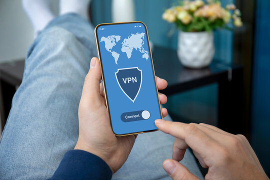 male hands hold phone with app vpn on screen room
