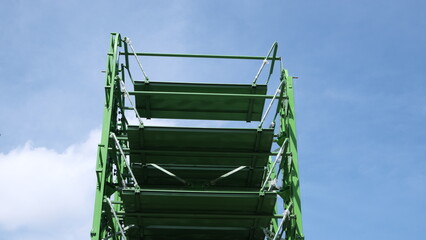 View of an automated vertical parking system against blue sky