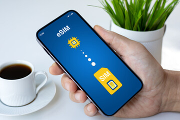 Man hand hold phone with Sim card replacement on eSim