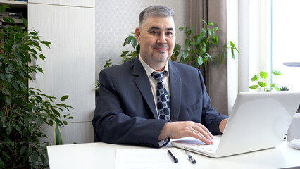 Confident Businessman in Suit Smiling at the Camera