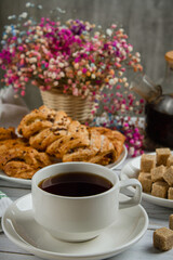 Cup of tea with dessert. Breakfast on a light table
