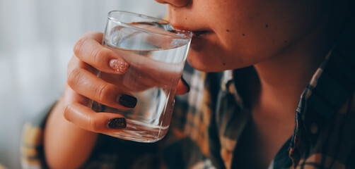 healthy beautiful young woman holding glass of water