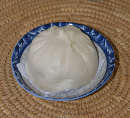 Stuffed steamed bun at dish on table