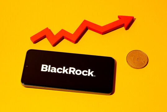 Kyoto city, Japan - august 22, 2024: BlackRock logo on the smartphone screen and red chart arrow near bitcoin coin on yellow background.