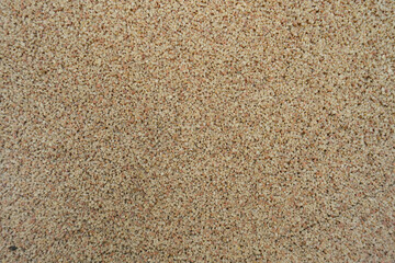 Close view of coarse beige and pink pebble dash finish