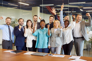 Corporate portrait of overjoyed diverse office employees workers show to recommend good quality...