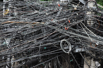 Hundreds of suspended electric cables crossing each other high above the city street