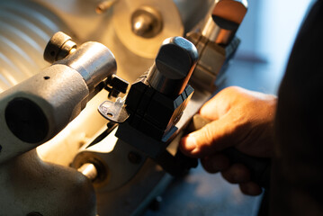 Hands are making dublicate of home keys manufacture
