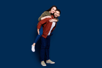 Photo of cheerful positive married couple wife husband wear stylish clothes mall store isolated on dark blue color background