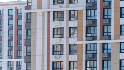 Fototapeta premium Moscow, March 19 2024, A large building with many windows and a clear blue sky in the background. The building is tall and has a modern look