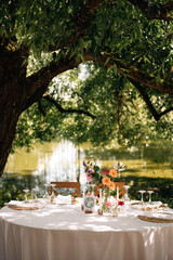 beautiful wedding decor. tables under the tree in the garden