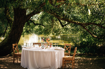 beautiful wedding decor. tables under the tree in the garden