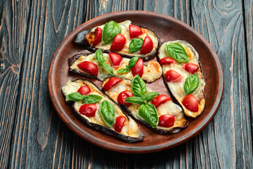 Italian mini pizza . Aubergine (eggplant ) with mozzarella cheese and basil . On rustic background