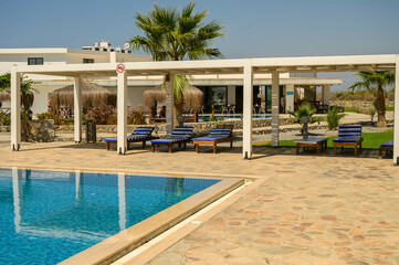 Modern pool area at a Mediterranean villa with sun loungers - luxury relaxation and outdoor living