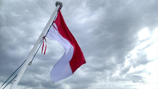 Flag of Indonesia Waving in the wind, Sky and Sun Background, Slow Motion, Realistic Animation, 4K UHD 60 FPS
