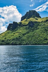 Portrait picture of the lush green hills of volcanic islands of the Yasawa archipelago, Fiji. Tropical paradise and a luxurious tourist destination. Beautiful, paradise-like small islands of Fiji. 