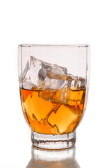 Glass with alcohol and ice cubes.
