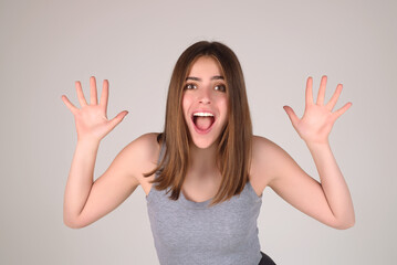 Girl raising eyebrows being surprised and shocked. Astonished reaction on unexpected news. Girl in t-shirt on isolated studio background with shocked, surprise and amazed expression on face.