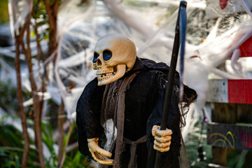 Naklejka premium Halloween pumpkin and skeleton for decorated house. Scary Decorated at front yard of a house. Decoration of the house for the holiday of Halloween. Pumpkin skeletons and terrible monsters.