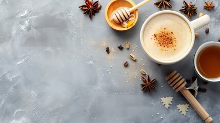 Coffee or tea based with milk and spices in an armudu cup with honey on a grey background