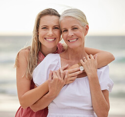 Portrait, beach and hug with mother, daughter and travel with smile, bonding together and ocean....