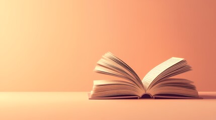 an open book on a table with a pink background
