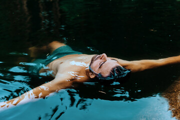 Man floating relaxed in calm water