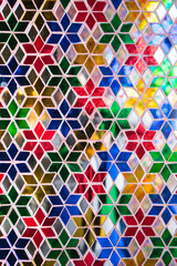 Colorful of pieces of glass in different colors to decorated on wall and column of the building. Abstract geometric background look like flower.