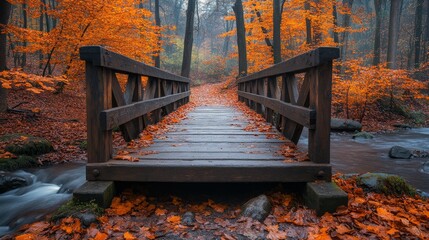 Obraz premium Rustic wooden bridge over a creek surrounded by colorful autumn foliage at a serene location
