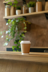 Mockup empty brown paper coffee cup on minimalist cafe shelf