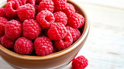 Freshly picked organic raspberries in a ceramic bowl, raspberry superfood, natural antioxidant and...