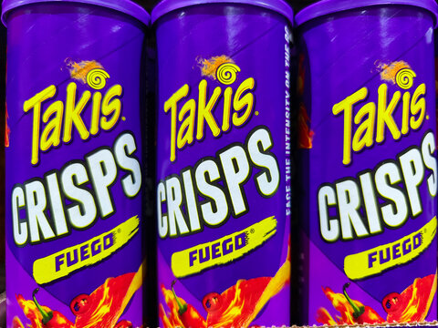 Colorful display of Takis Fuego crisps snack packaging