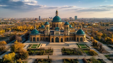 Fototapeta premium A majestic yellow building with teal domes and a symmetrical garden in front of it under a blue sky.