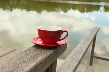 A man is drinking coffee in red cup color