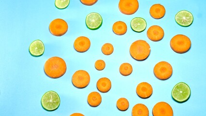 Organic fresh fruits carrot and lemon on blue background