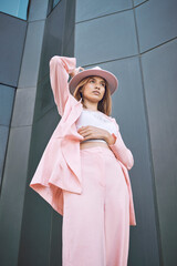 Thinking, woman and fashion in city with confidence, attitude and designer clothing. Stylish, pink...