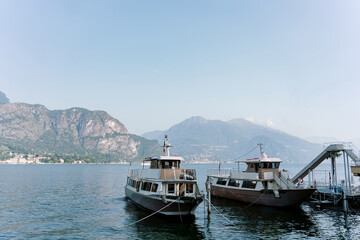 A boat sails on a mountain lake in Italy